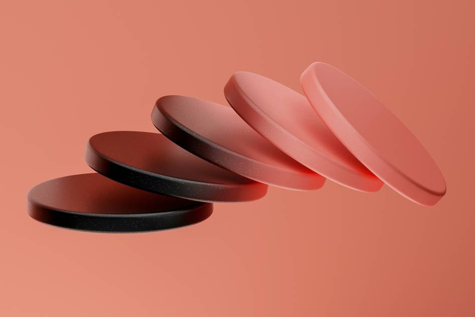A close-up of soft makeup sponges arranged with beauty products