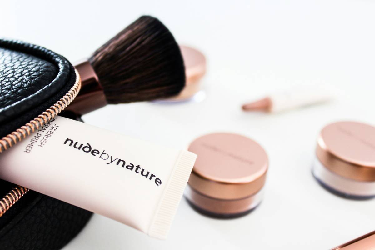 clean foundation blending sponge kit laid out on white marble surface with skincare products